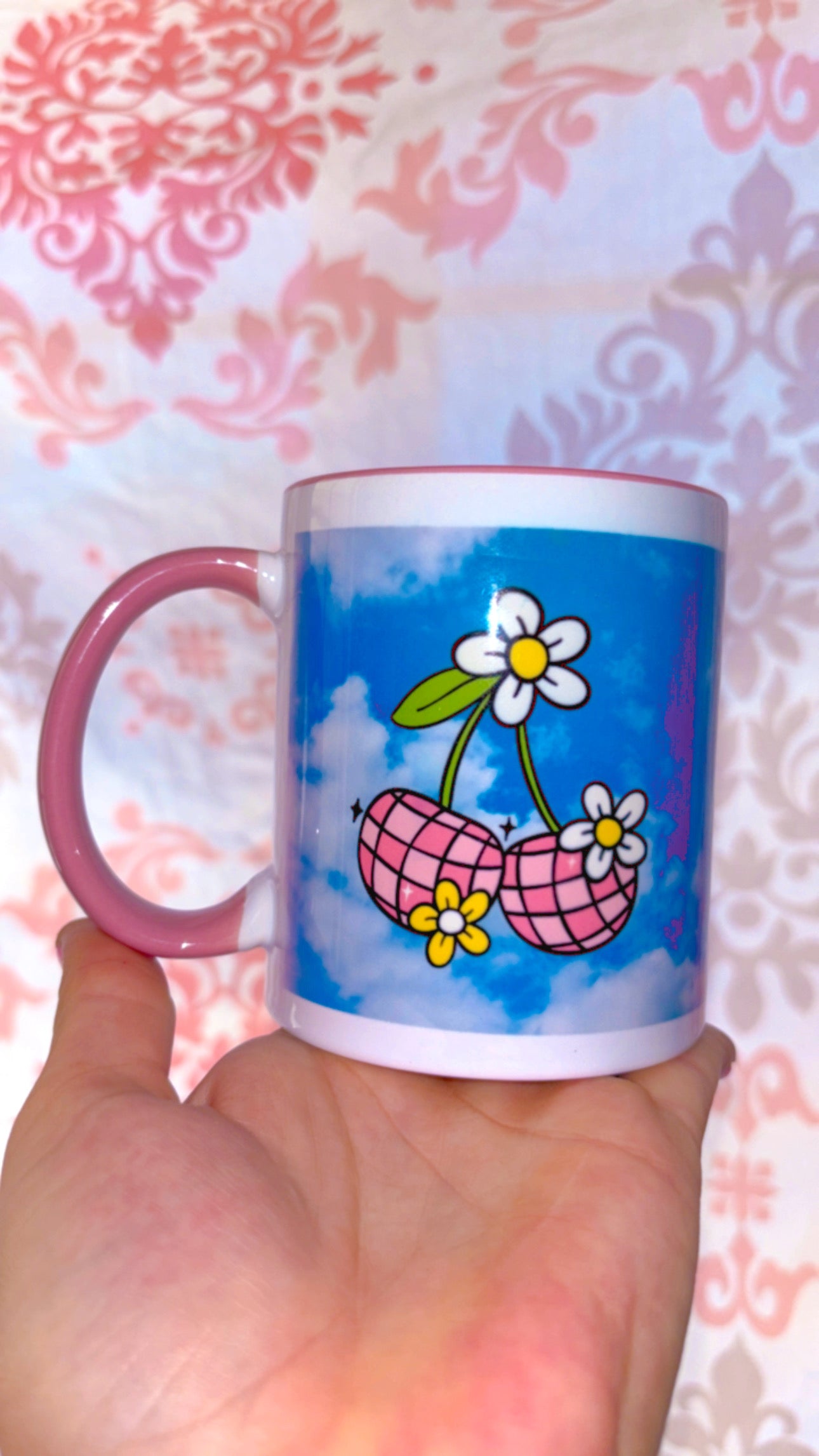 Pink disco cherries with flowers on a sky blue background with pink handle and inside