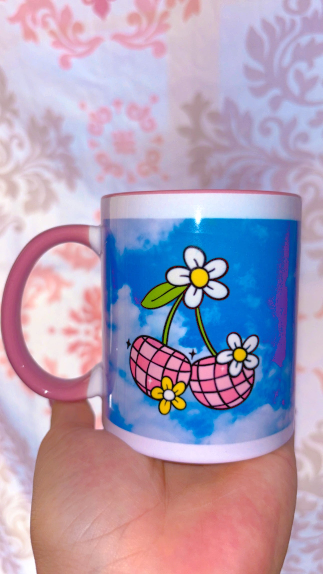 Pink disco cherries with flowers on a sky blue background with pink handle and inside