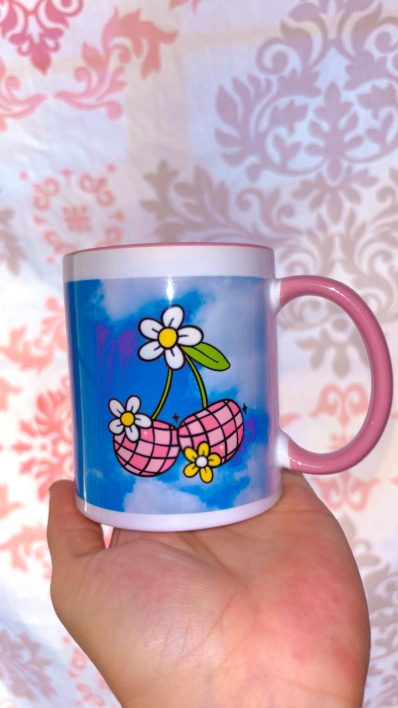 Pink disco cherries with flowers on a sky blue background with pink handle and inside